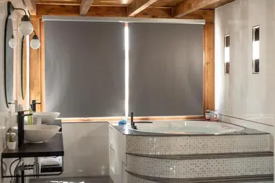 a bathroom with a large tub and a sink at Atico Con Encanto Centro in Jerez de la Frontera