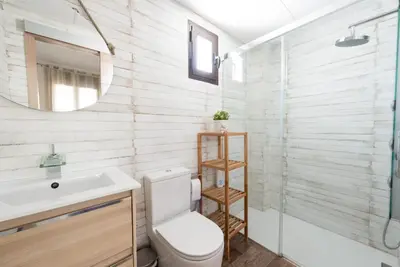 a bathroom with a toilet and a sink and a mirror at Atico Con Encanto Centro in Jerez de la Frontera