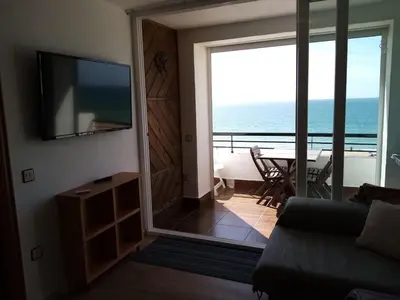 a living room with a view of the ocean at La Barrosa beach Chiclana in Novo Sancti Petri