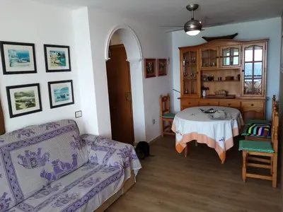 a living room with a table and a couch at La Barrosa beach Chiclana in Novo Sancti Petri