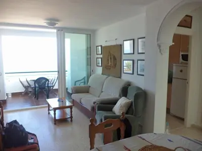 a living room with a couch and a table at La Barrosa beach Chiclana in Novo Sancti Petri