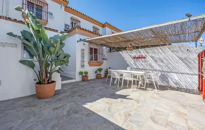 a patio with a table and chairs in a building at Nice Home In Chiclana De La Fronter in Novo Sancti Petri