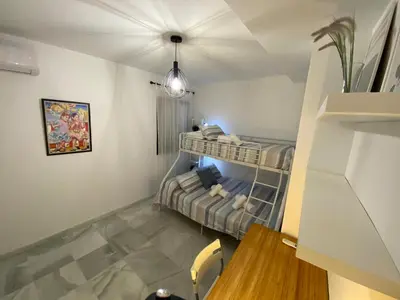 a bedroom with a bunk bed and a desk at Dúplex Casco Histórico, terraza, garaje in Sanlúcar de Barrameda