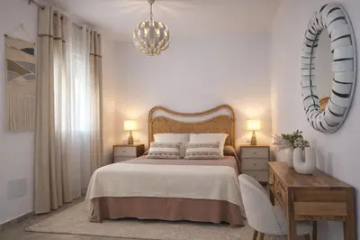 a bedroom with a bed and a mirror on the wall at Chalet con piscina en Naveros in Los Naveros