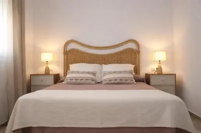 a bedroom with a large bed with two night stands at Chalet con piscina en Naveros in Los Naveros