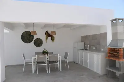 a kitchen and dining room with a table and chairs at Chalet con piscina en Naveros in Los Naveros
