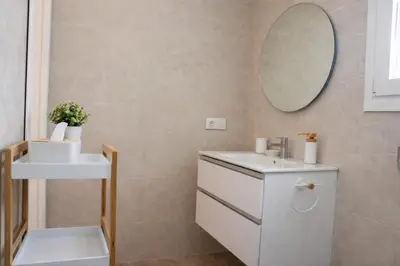a bathroom with a white sink and a mirror at Chalet con piscina en Naveros in Los Naveros