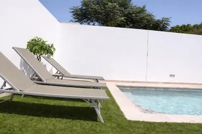 a pair of lounge chairs next to a swimming pool at Chalet con piscina en Naveros in Los Naveros