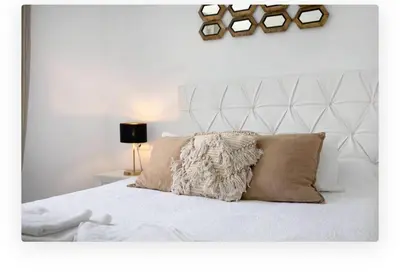 a bedroom with a white bed with a pillow on it at Casa Dana in Cádiz