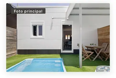 a swimming pool in the yard of a house at Casa Dana in Cádiz