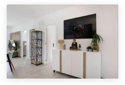 a living room with a table with a camera on the wall at Casa Dana in Cádiz