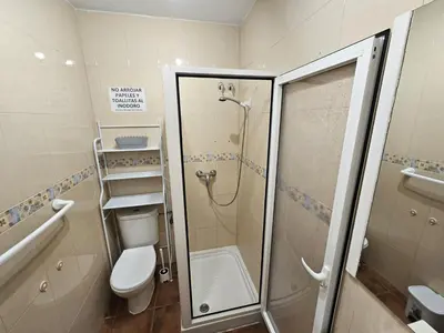 a bathroom with a shower and a toilet at Apartamento Pepa in Chipiona