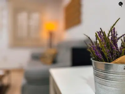a metal bucket with purple flowers on a kitchen counter at La Caleta Prime Grupo AC Gestion in Cádiz