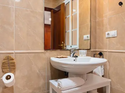 a bathroom with a sink and a mirror at La Caleta Prime Grupo AC Gestion in Cádiz