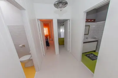 a white bathroom with a toilet and a sink at La Buganvilla, bright and spacious apartment in the city centre in Chipiona