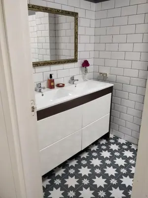 a bathroom with a white sink and a mirror at La Buganvilla, bright and spacious apartment in the city centre in Chipiona