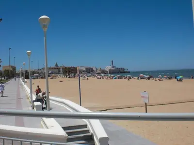 a street light next to a beach with buildings at Apartment Penthouse- Klimatisierung- Strand und Sonne das ganze Jahr über by Interhome in Chipiona