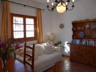 a living room with a white couch and a table at Apartment Penthouse- Klimatisierung- Strand und Sonne das ganze Jahr über by Interhome in Chipiona