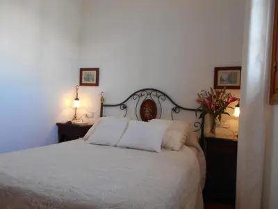 a bedroom with a white bed with two pillows at Apartment Wohnung 'Caracola' mit Terrasse by Interhome in Chipiona