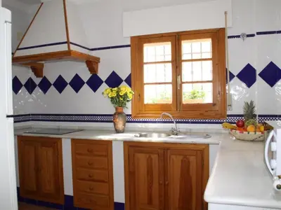a kitchen with a sink and a vase of flowers at Apartment Wohnung 'Caracola' mit Terrasse by Interhome in Chipiona