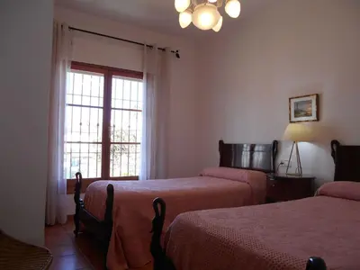 a bedroom with two beds and a window at Apartment Wohnung Klimaanlage- Wifi- Terrasse- by Interhome in Chipiona