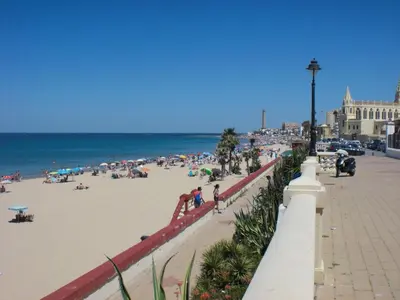 a group of people on the beach near the ocean at Apartment Wohnung Klimaanlage- Wifi- Terrasse- by Interhome in Chipiona