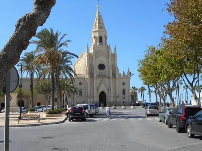 a church with cars parked in front of it at Apartment Wohnung Klimaanlage- Wifi- Terrasse- by Interhome in Chipiona