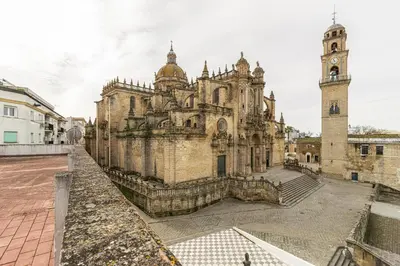 an old building with a clock tower and a church at Allo Apartments Catedral Centro 3 Habitaciones in Jerez de la Frontera