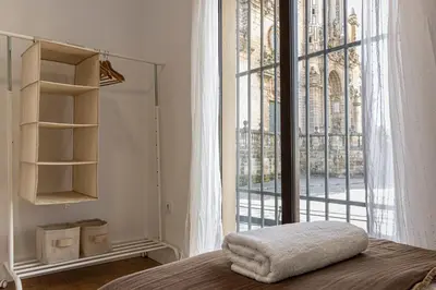 a bedroom with a bed with a large window at Allo Apartments Catedral Centro 3 Habitaciones in Jerez de la Frontera