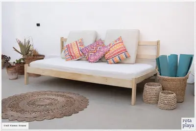 a couch with four pillows on it in a room at Relaxing Seaside Getaway in the Heart of Rota in Rota