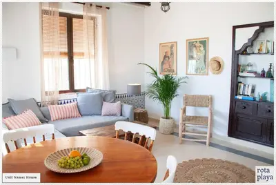 a living room with a table and a couch at Relaxing Seaside Getaway in the Heart of Rota in Rota