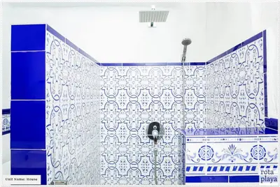 a bathroom with a blue and white tiled wall at Relaxing Seaside Getaway in the Heart of Rota in Rota