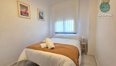 a bedroom with a bed with two towels on it at Corrala Juan Grande 2 con garaje by Sanlúcar Housing in Sanlúcar de Barrameda