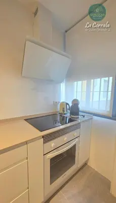 a kitchen with a sink and a stove top oven at Corrala Juan Grande 2 con garaje by Sanlúcar Housing in Sanlúcar de Barrameda