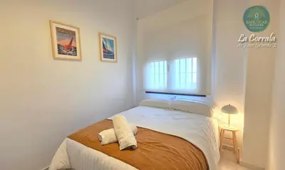 a bedroom with a bed with two towels on it at Corrala Juan Grande 2 con garaje by Sanlúcar Housing in Sanlúcar de Barrameda