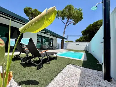 a house with a pool and a surfboard on top of it at Casa Lumier in Chiclana de la Frontera