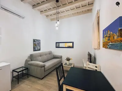 a living room with a couch and a table at Los Callejones de la Pepa Grupo AC Gestion in Cádiz