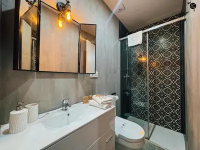 a bathroom with a toilet and a sink and a shower at Los Callejones de la Pepa Grupo AC Gestion in Cádiz