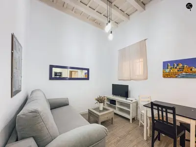 a living room with a couch and a table at Los Callejones de la Pepa Grupo AC Gestion in Cádiz