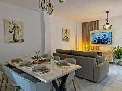 a living room with a dining table and a couch at Apartamento Castellanos - Ole Solutions in Jerez de la Frontera