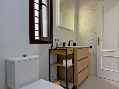 a bathroom with a sink and a toilet and a mirror at Apartamento Castellanos - Ole Solutions in Jerez de la Frontera