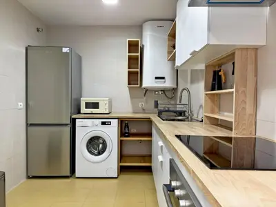 a kitchen with a refrigerator and a washing machine at Apartamento Castellanos - Ole Solutions in Jerez de la Frontera