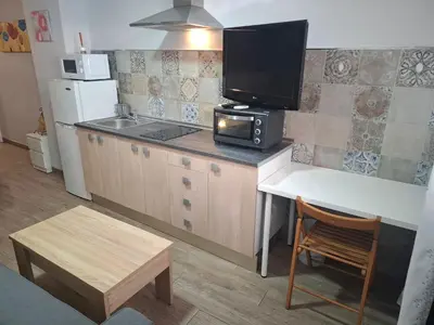 a living room with a couch and a bed at Apartamento Playa Enamorados in El Puerto de Santa María