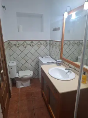 a living room with a couch and a tv at Apartamento Playa Enamorados in El Puerto de Santa María