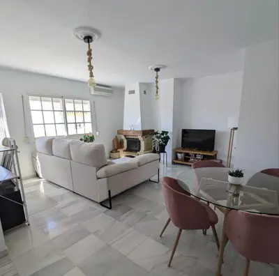 a living room with a couch and a table at Molly's Sunny Penthouse in Sanlúcar de Barrameda