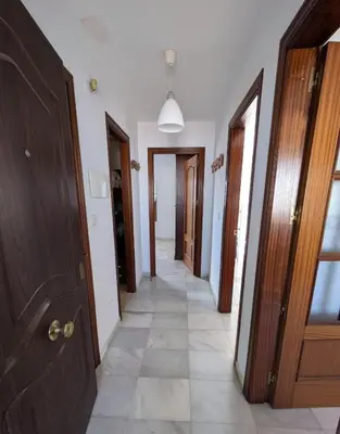 a hallway with many different types of doors at Molly's Sunny Penthouse in Sanlúcar de Barrameda
