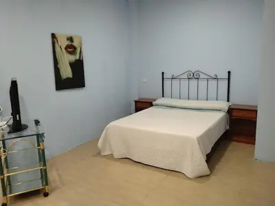 a bedroom with a bed and a painting on the wall at Cádiz bahía in Cádiz