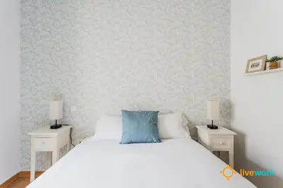 a bedroom with a white bed with two night stands at The Hideaway of Cádiz by livework in Cádiz
