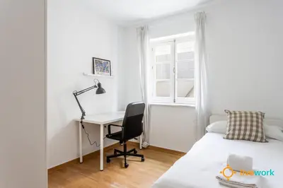 a bedroom with a desk and a bed and a desk and a chair at The Hideaway of Cádiz by livework in Cádiz