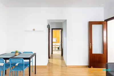 a dining room with a table and blue chairs at The Hideaway of Cádiz by livework in Cádiz